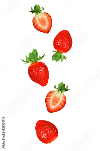 Falling strawberries fruits whole and cut in half isolated on white background with clipping path. Flying food