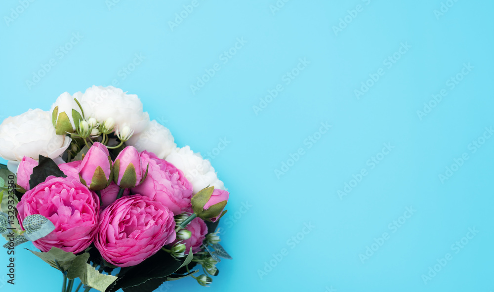 Pink and white flowers on blue background. Mother’s Day, Spring concept. Greeting, invitation card. Flat lay, top view style with copy space for your text. Pink and white flowers on blue background. Mother’s Day, Spring concept. Greeting, invitation card. Flat lay, top view style with copy space for your text.
