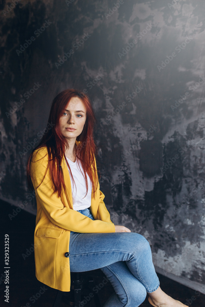 Close up portrait of a young natural beautiful girl with freckles on grey background. Natural beauty, caucasian freckled girl concept