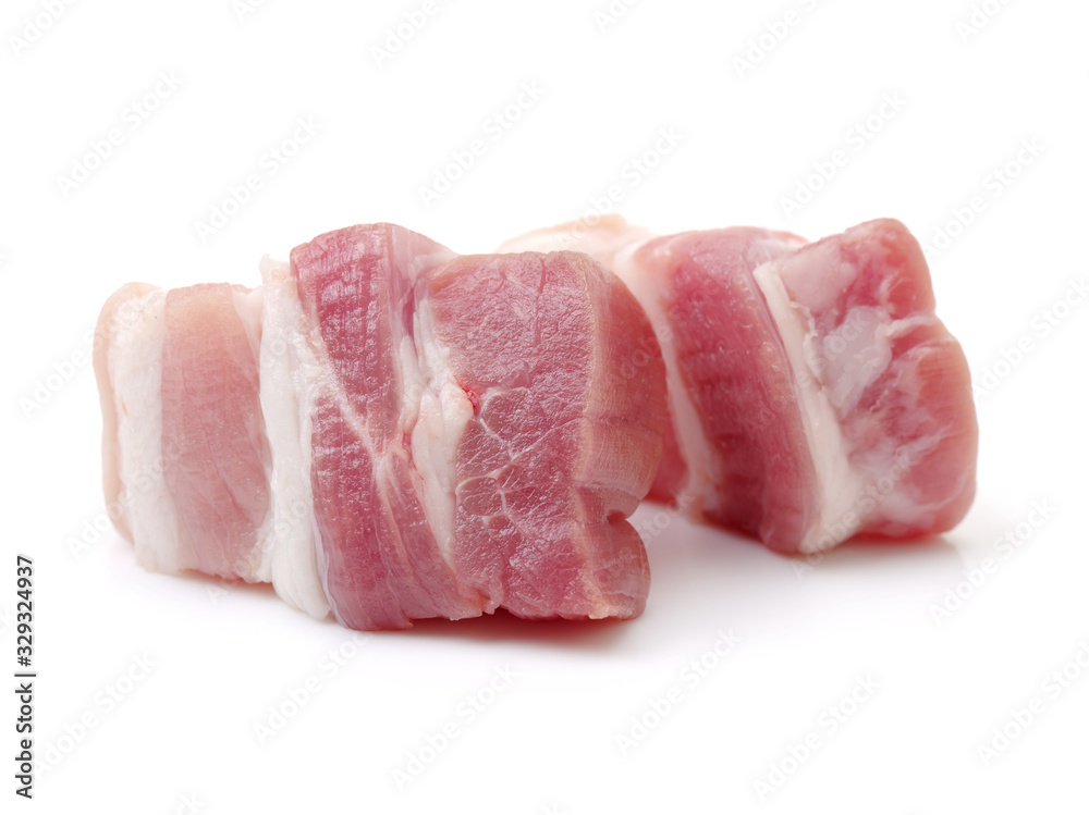 Raw pork belly pieces on a white background