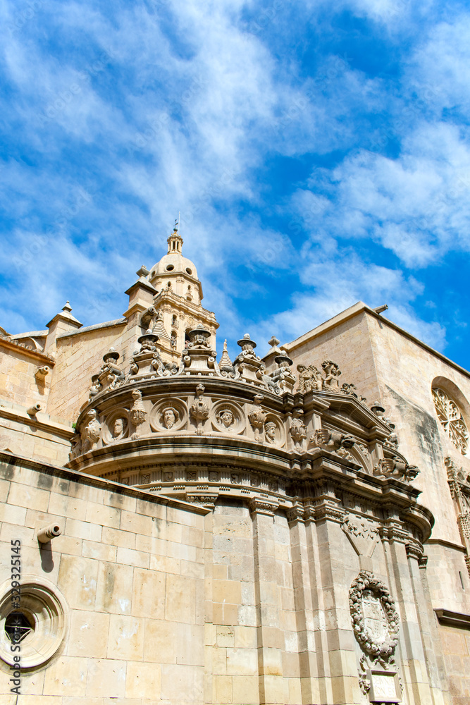 The beautiful cathedral of Saint Mary in the Spanish city of Murcia.  Elaborate carvings adorning the roof of this grand building.