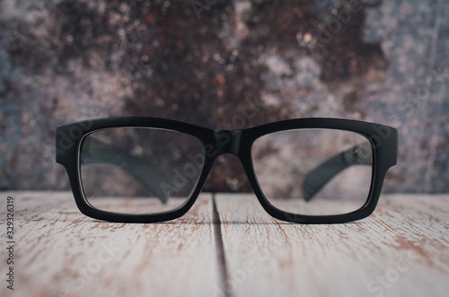 black frame eye glasses on wooden desk