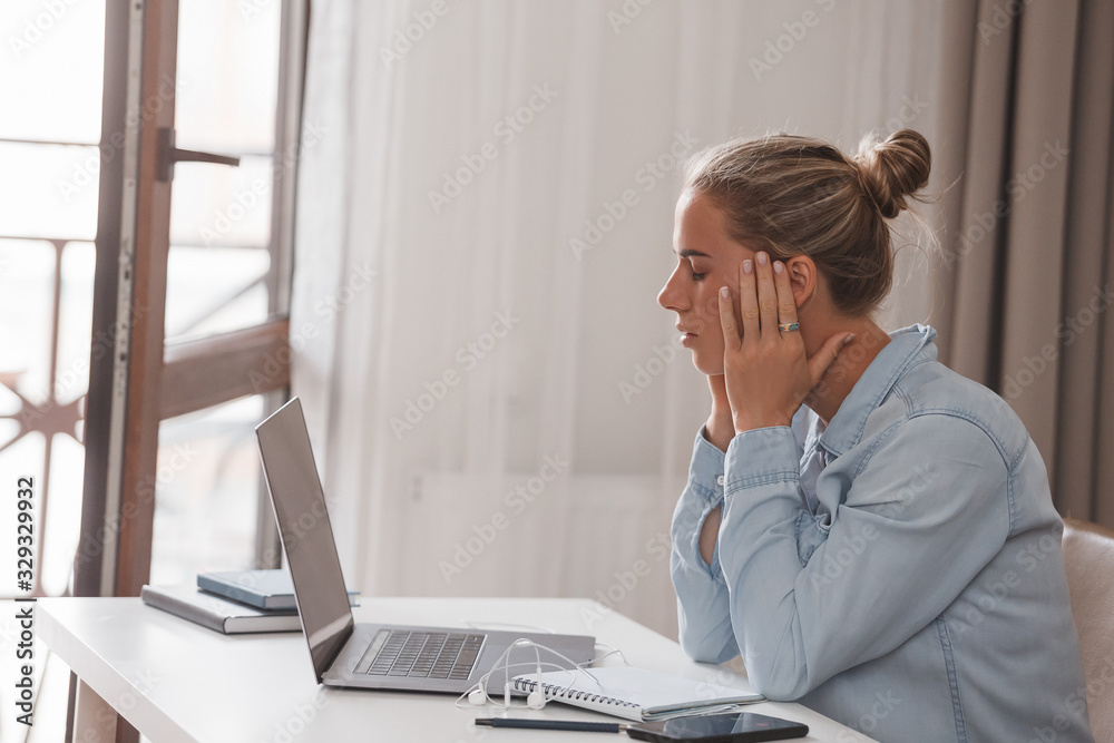 Young beautiful girl student is sick with dementia, feels bad, suffers from a headache, relieves stress. Female model in casual wear is trying to independently learn new courses on online training Young beautiful girl student is sick with dementia, feels bad, suffers from a headache, relieves stress. Female model in casual wear is trying to independently learn new courses on online training