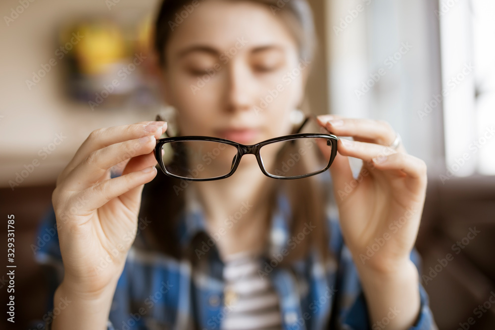 Fototapeta premium Optical eyeglasses in the female hands