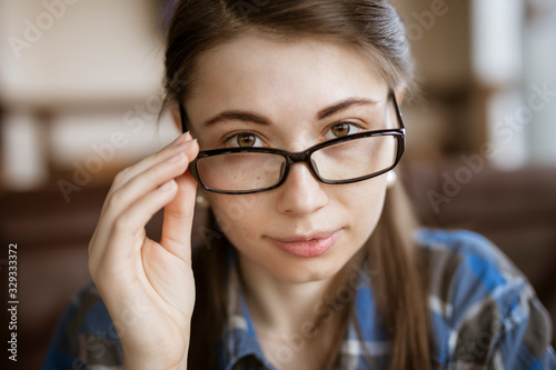 Myopia or hyperopia, woman try on optical eyeglasses