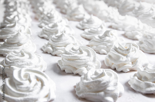 on a white pastel background lies a fresh white handmade marshmallow. copy space