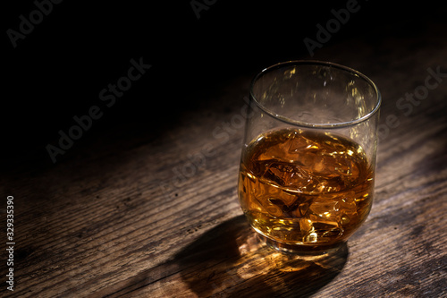 Glass of Whiskey Against Dark Rustic Background