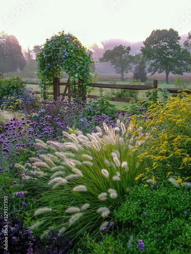 Leinwand Poster Vertical image of a beautiful country garden in fall with flowers, herbs, shrubs