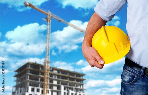 Worker man with a hard hat in his hand photo