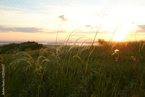 The concept of tourism and solitude with nature. Beautiful pink sunrise on a plain overlooking the river. 