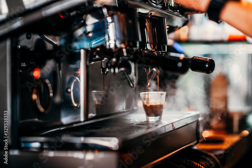 close-up image of the coffee machines that are operating automatical Coffee flowing into coffee cup that is prepar for service Coffee aroma bake the whole shop and the shop atmosphere that look warm
