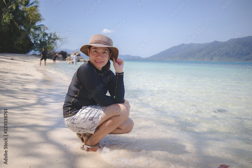 Portrait of young woman  on tropical beach 
