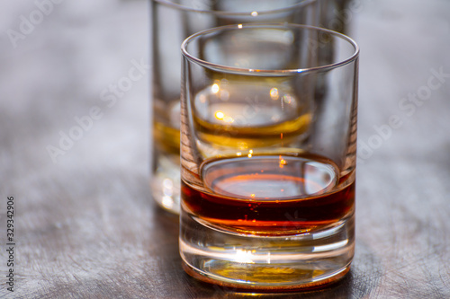 Tasting of flight of Scotch whisky from tumbler glasses in old Edinburgh pub, Scotland, UK