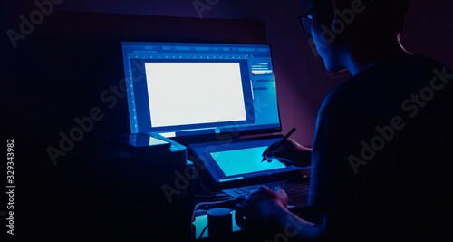 freelance designer working at night in his home. with copyspace photo