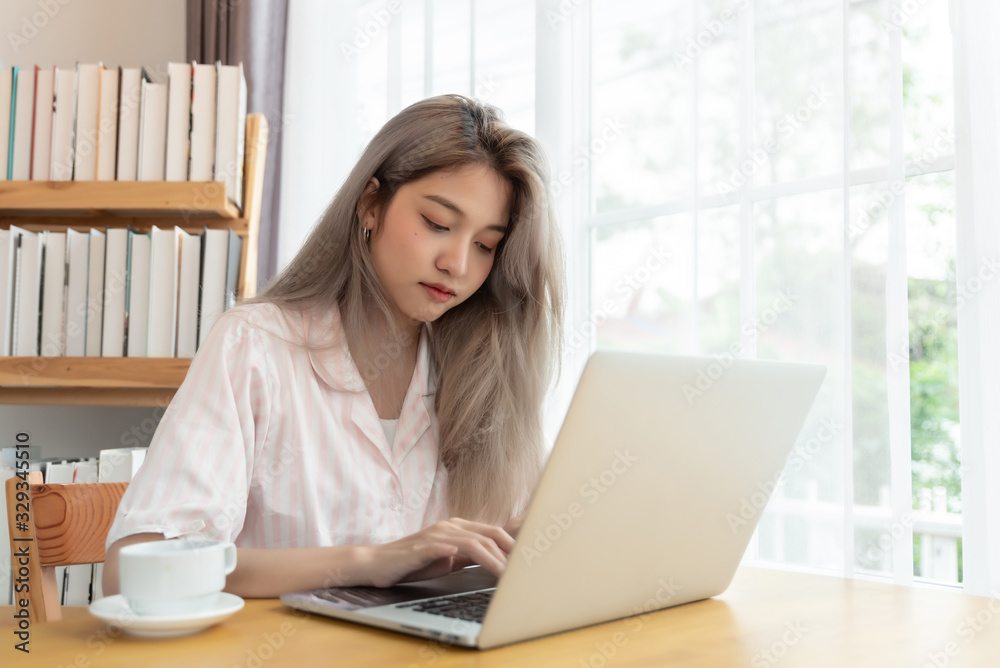 Lazy bored asian woman using laptop in the morning. Work from home Lazy bored asian woman using laptop in the morning. Work from home