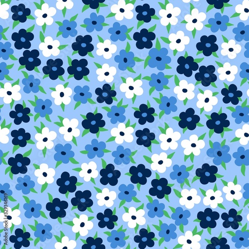 Cute floral seamless pattern. Modern disty delicate design with white and blue simple flowers and green leaves. Fashion print with spring motif.