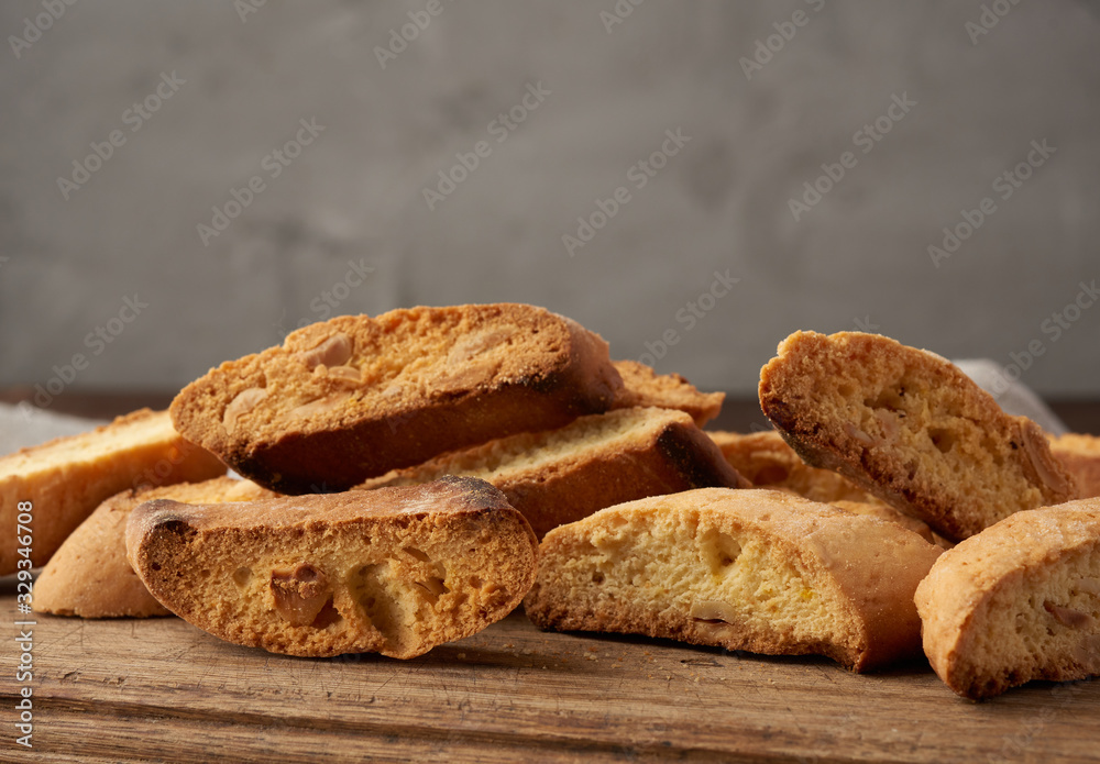 pieces of baked italian christmas biscotti cookies on a brown wooden board