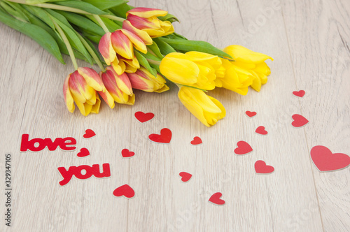 Yellow tulips over wooden table background with copy space