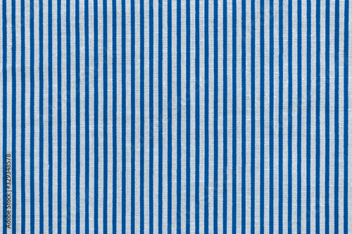 Classic blue and white striped fabric texture. Bright colored cotton background