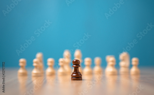 Brown chessman standing in front of white chess  Concept of a new startup must have courage and challenge in the competition  leadership and business vision for a win in business games
