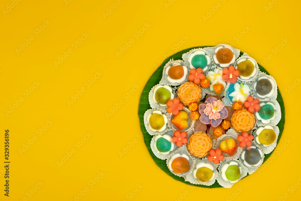 A lot of kind of Thai dessert pastel color in basket ready to show isolate on yellow background.