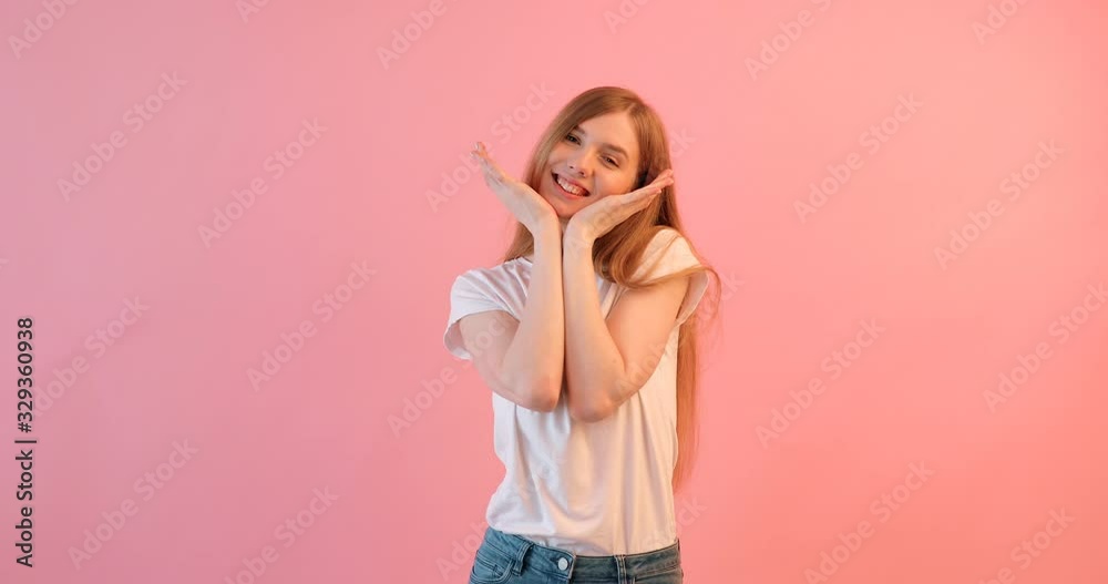 Portrait of an enthusiastic young girl, screaming with joy, on a pink background Portrait of an enthusiastic young girl, screaming with joy, on a pink background