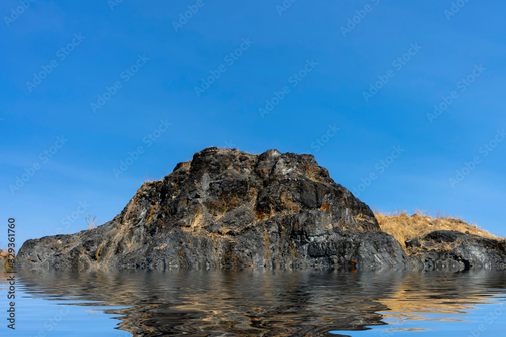 Granite mountains with blue sky background.