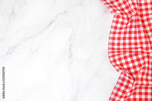 Red picnic cloth on table top view,checkered gingham towel on whote background empty space.