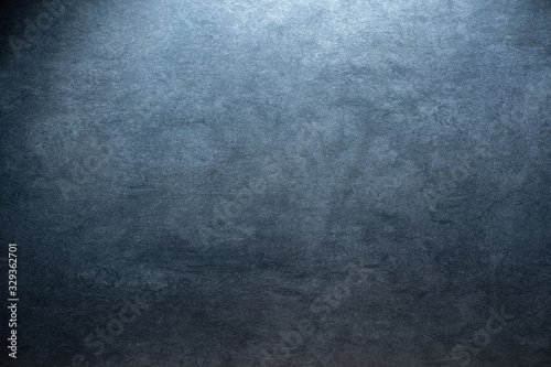 cold colored grunge stone background texture with radial gradient and copy space