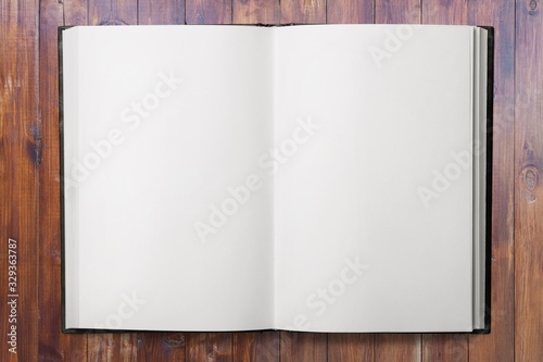 Open blank notebook on a wooden desk
