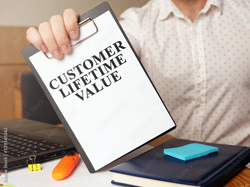 Man is holding Customer lifetime value report. Man is holding Customer lifetime value report.