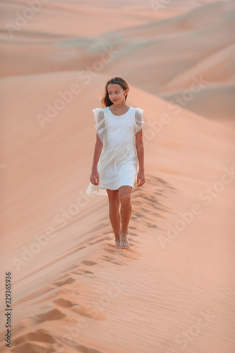 Girl among dunes in desert in United Arab Emirates © travnikovstudio