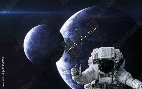 Fototapeta Naklejka Na Ścianę i Meble -  Astronaut, space station on background of planets in deep space. Science fiction. Elements of this image furnished by NASA