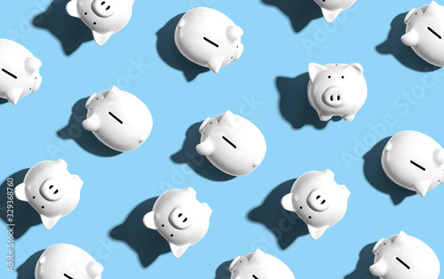 White piggy banks overhead view - flat lay