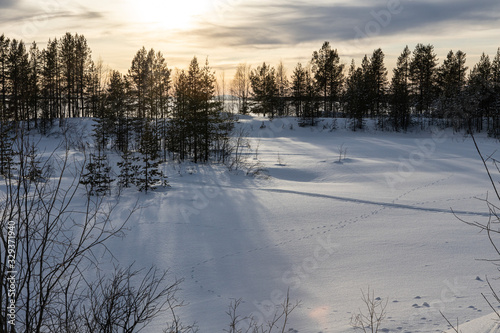 Winter landscape - snow-capped lake mountain and trees in the distance