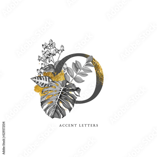 Decorated O letter with hand drawn tropical leaves photo