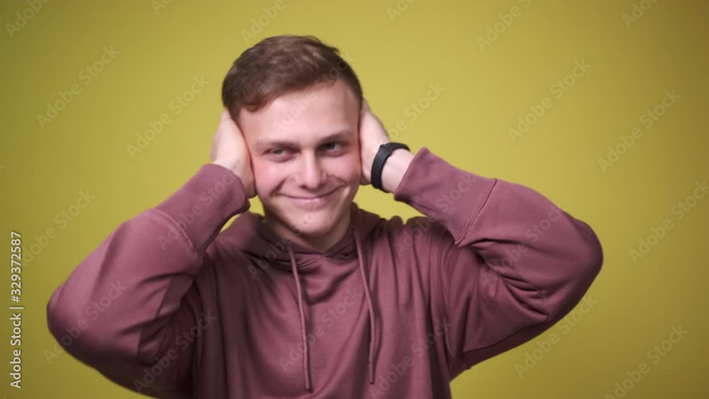 Man covering ears gesturing dont want to hear gossip Man covering ears gesturing dont want to hear gossip