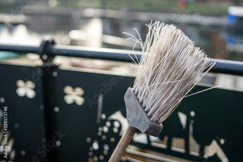 A close up of the head of a roadsweepers broom or brush with selective focus on the bristles
