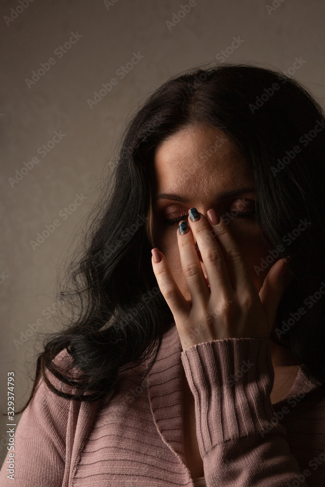 Nervous woman posing in the shadow Nervous woman posing in the shadow