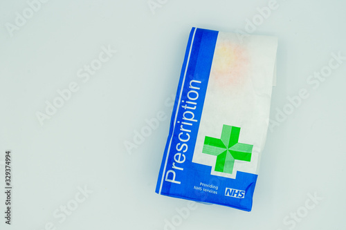 A British NHS prescription paper bag isolated on a white background photo