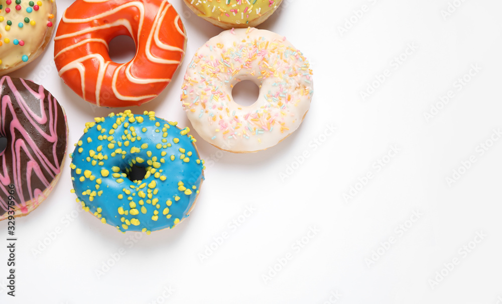 Delicious glazed donuts on white background, flat lay. Space for text Delicious glazed donuts on white background, flat lay. Space for text