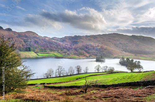 A view of Rydal Water on a clam day taken from the Coffin Route showing Loughrigg Fell in the distance near Grasmere.  photo