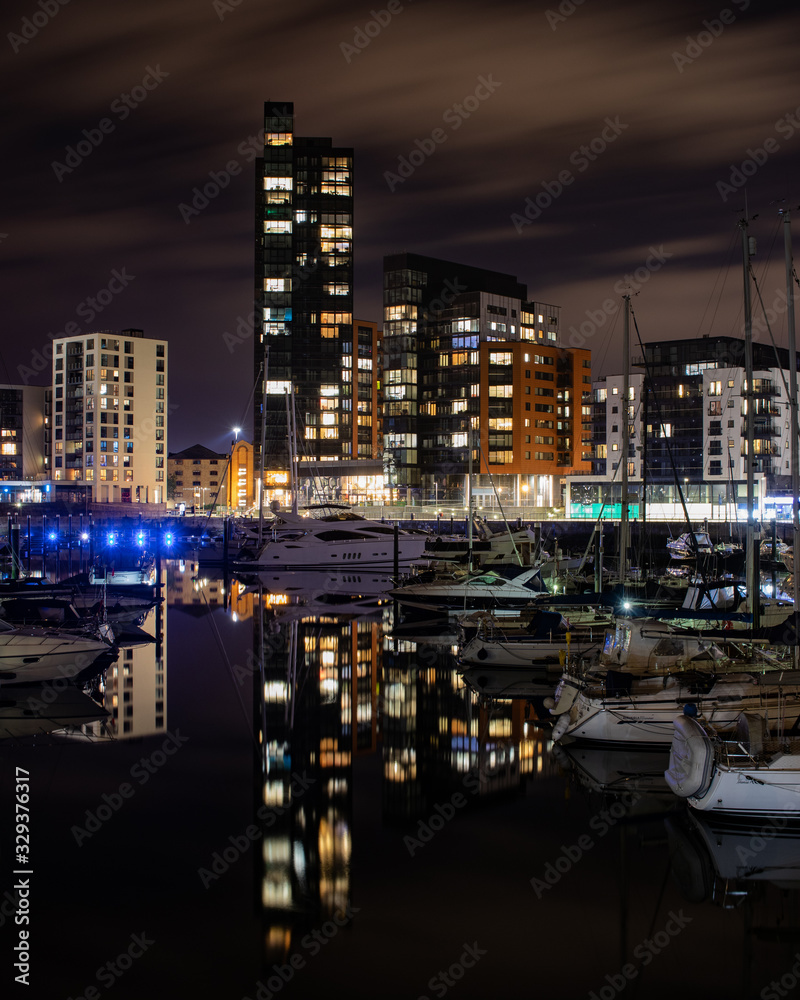 Ocean Village marina at night reflecting on calm waters with yachts docked at a jetty