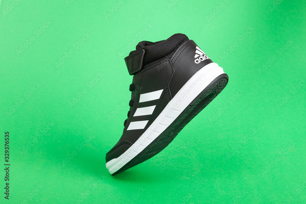 Forbavselse håndjern Lavet af Varna , Bulgaria - SEPETEMBER 27, 2019 : ADIDAS sport shoe, on green  background. Product shot. Adidas is a German corporation that designs and  manufactures sports shoes, clothing and accessories Stock-foto | Adobe Stock