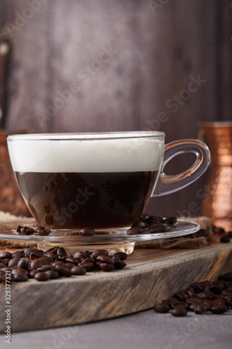 Cappuccino is an espresso-based coffee drink and steamed milk foam made from coffee in a transparent glass cup. Hot coffee with steam