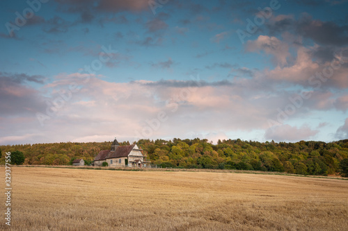 St Hubert's Church, Idsworthan old english church surrounded by wheat fields on a hill photo