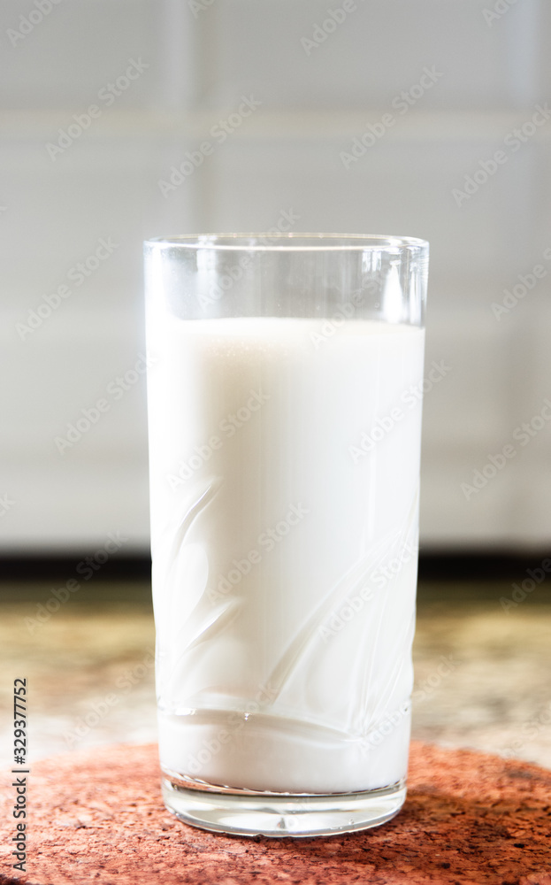 Glass of milk on a wooden stand Glass of milk on a wooden stand