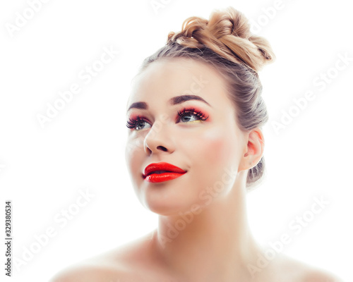 young blond real woman with bright make up smiling pointing gesturing emotional isolated like doll lashes