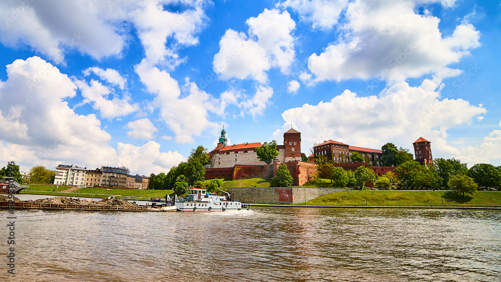 Wawel castle - famous landmark in Krakow Poland. Picturesque landscape on coast Vistula river during the sunny day.