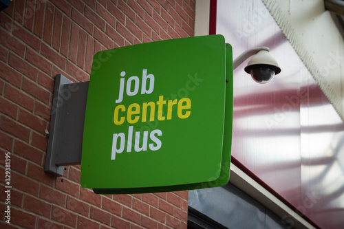 a jobcentre plus sign and a security camera